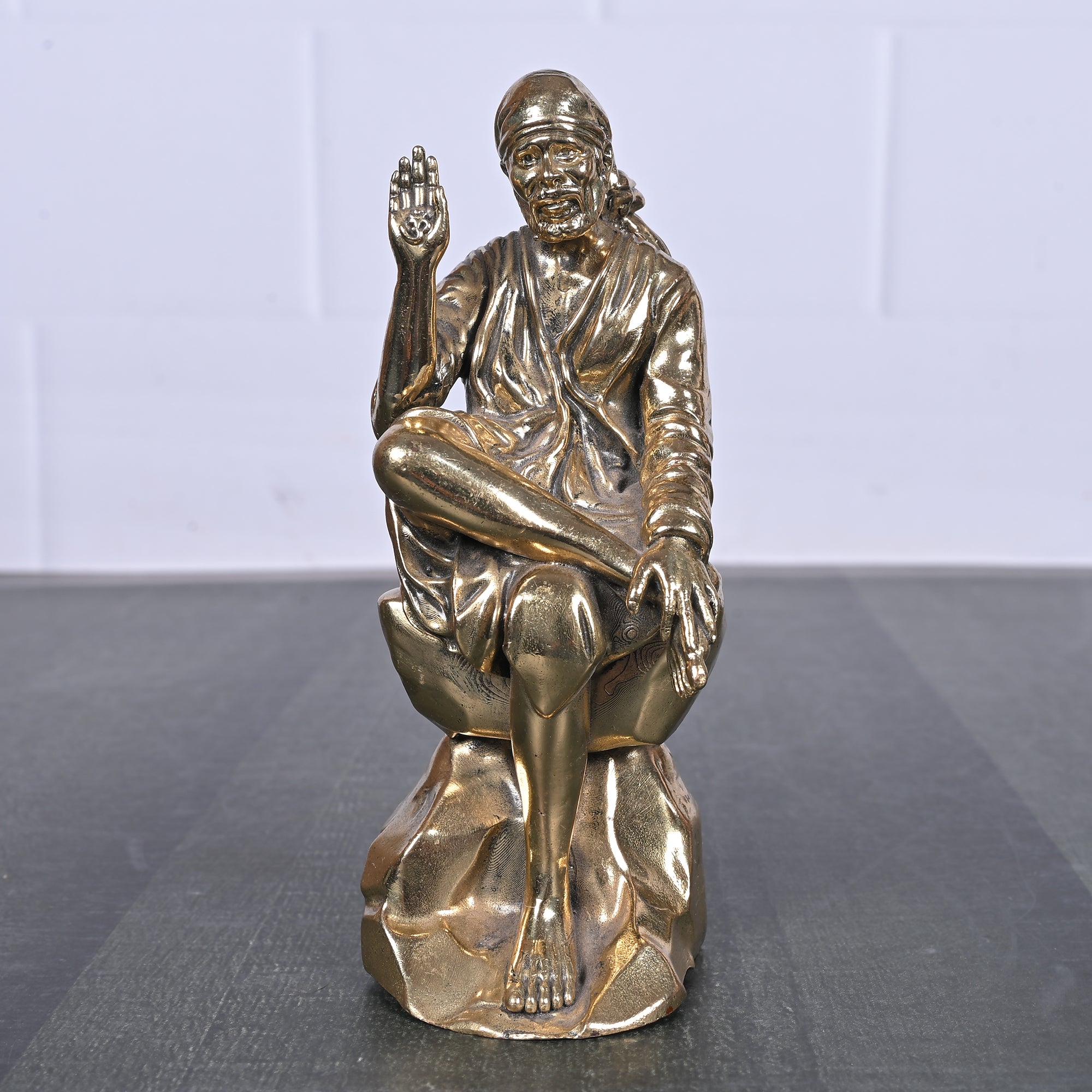 Brass Sai Baba Sitting on Rock 5 Inch