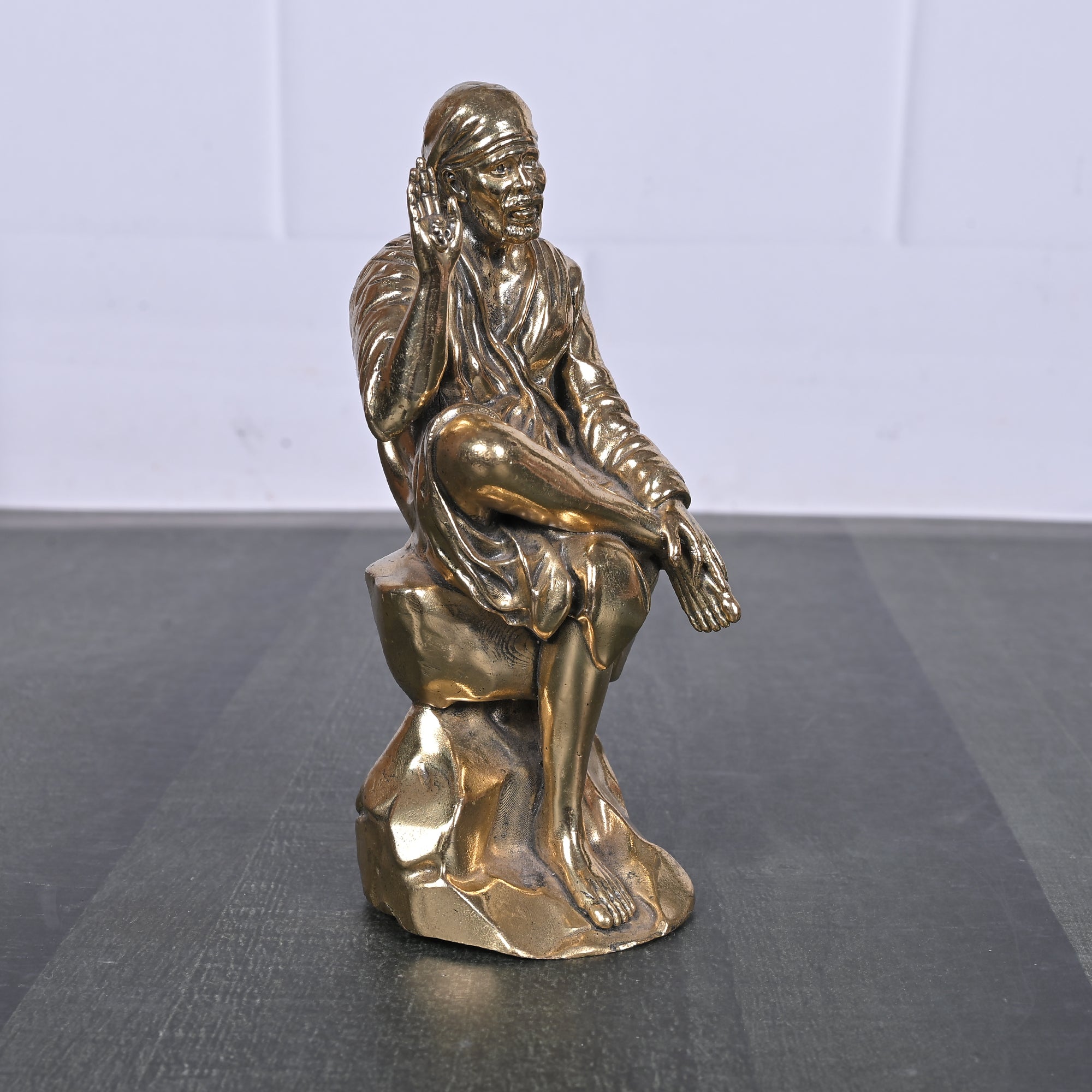 Brass Sai Baba Sitting on Rock 5 Inch